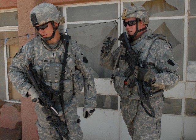 BAGHDAD - Lt. Michael Keckler (left), of Bel Air, Md., and 1st Sgt. Harry Buchanan of Altoona, both with Company B, 2nd Battalion, 112th Infantry Regiment, 56th Stryker Brigade Combat Team, discuss an ongoing search for explosives, May 19. The...