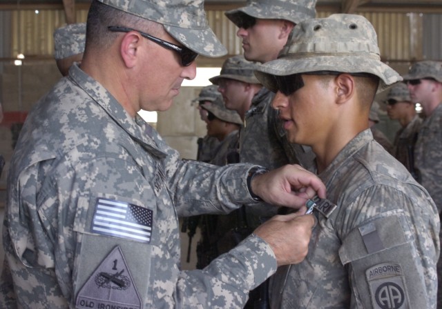 BAGHDAD - Maj. Gen. Curtis Scaparrotti, commander of the 82nd Airborne Division, awards the Army Commendation Medal with Valor to Pfc. Theodore Medina, of Denver, Colo., assigned to Troop A, 5th Squadron, 73rd Cavalry Regiment, 3rd Brigade Combat...