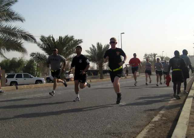 BAGHDAD - Runners on the final stretch sprint to the finish line at the Asian Pacific Heritage five kilometer run on Victory Base Complex May 16. Soldiers from the 299th Brigade Support Battalion, 2nd Heavy Brigade Combat Team, 1st Infantry Division,...