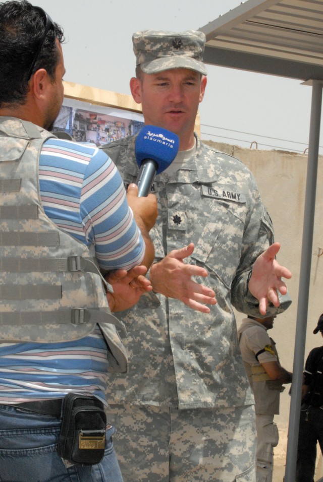 BAGHDAD - Lt. Col. John Richardson, of Tallahassee, Fla., commander of 5th Squadron, 4th Cavalry Regiment, 2nd Brigade Combat Team, 1st Infantry Division, speaks with an Iraqi reporter, May 20, about the improvements made in Ghazaliyah.  "We are...