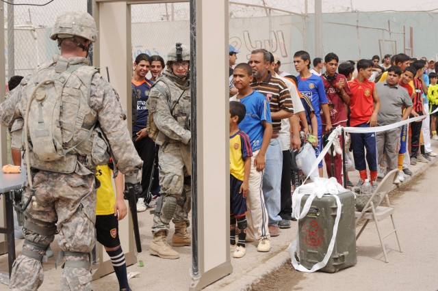 BAGHDAD - Paratroopers assigned to the Brigade Special Troops Battalion, 3rd Brigade Combat Team, 82nd Airborne Division, Multi-National Division - Baghdad, use metal detectors in front of Shaab Stadium, May 22, before the FC Unity soccer tournament ...