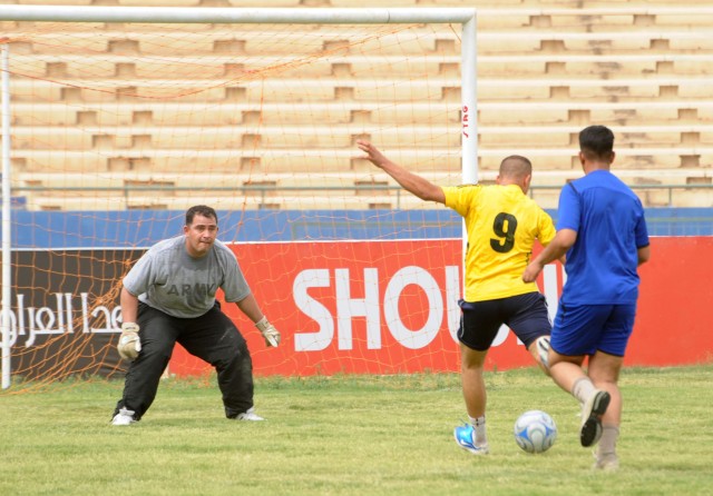 BAGHDAD - A Paratrooper assigned to the 3rd Brigade Combat Team, 82nd Airborne Division, Multi-National Division - Baghdad, takes a shot on goal during a soccer match at Shaab Stadium May 22 in the Rusafa district of eastern Baghdad. Thirty-six socce...