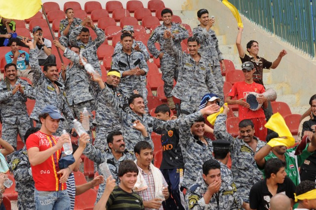 BAGHDAD - National Police officers cheer following a goal during a game a FC Unity soccer game at Shaab Stadium May 22 in the Rusafa district of eastern Baghdad. Four combined U.S. - Iraqi forces matches were played during the tournament in which mix...