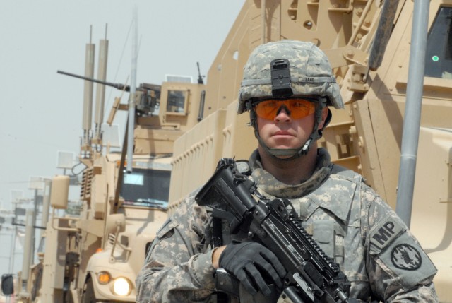 BAGHDAD - Pfc. Michael Lang, from Ritchfield N.H., native, a military policeman assigned to the 591st Military Police Company, 93rd MP Battalion, 8th MP Brigade, secures his perimeter before the "Spartans" begin their dismounted patrol in the Abu...