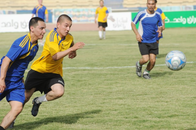 BAGHDAD - Paratroopers assigned to the 3rd Brigade Combat Team, 82nd Airborne Division, Multi-National Division-Baghdad, run to gain control of the ball during the finals of the combined forces soccer match at Shaab Stadium May 23 in the Rusafa...