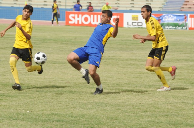 BAGHDAD - A member of an Iraqi community soccer team attempts to control possession of the ball during a soccer game at Shaab Stadium, May 23, in the Rusafa district of eastern Baghdad. The game was part of the FC Unity tournament held this past...