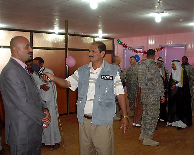 BAGHDAD- Abu Amir, a local businessman and renovator of the Mahmudiyah Sewing and BeautyVotech School, is interviewed by Jawad Al-Shammary Al-hurriyati during the school's grand opening ceremony May 21.  The first iteration of classes are...