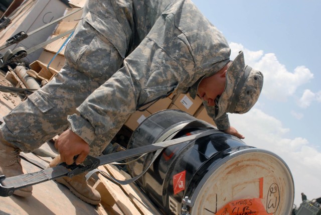 CAMP TAJI, Iraq- Grand Island, Neb. Native, Spc. Jerry Smith, a truck commander for Troop D, 1st Squadron, 7th Cavalry Regiment, 1st Brigade Combat Team, 1st Cavalry Division, tightens a ratchet strap in order to secure equipment scheduled for delive...