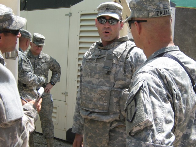 BAGHDAD- Sgt. Richard Dusenberry (center), electrician, 46th Engineer Combat Battalion (Heavy), a native of Orion, Ill., briefs Lt. Col. Matthew Zajac (right), commander, 46th Engineer Combat Battalion (Heavy), 225th Engineer Brigade and other key le...