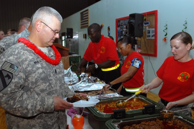 CAMP LIBERTY, Iraq - Command Sgt. Maj. Rory Malloy, senior enlisted advisor, Multi-National Divisio-Baghdad and the1st Cavalry Division, samples some ethnic cuisine at an Asian-Pacific American Heritage Month celebration here, May 22. The spread cont...