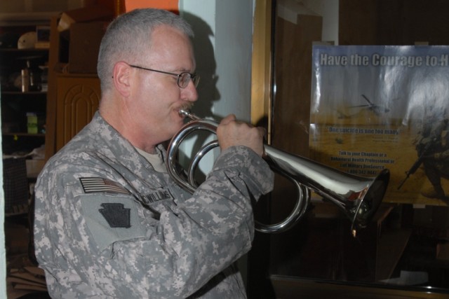 CAMP TAJI, Iraq - Master Sgt. Jon McWilliams, chaplain assistant, from Lancaster Pa., plays Taps during the Memorial Day service, May 25, at the Warrior Chapel for Soldiers of the 56th Stryker Brigade Combat Team, 1st Cavalry Division,...