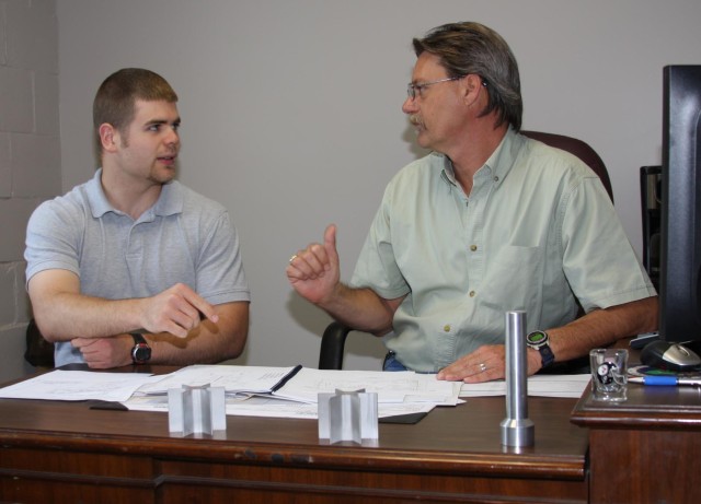 EKU student team member Samuel Arnold (left) worked with Timothy Delozier, the Depot&#039;s 81mm mortar cartridge fin assembly project officer.