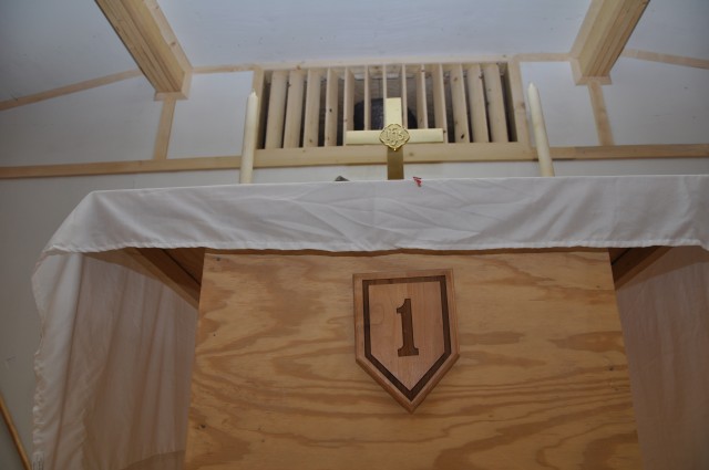 KANDAHAR AIRFIELD, Afghanistan - The 1st Infantry Division's famous "Big Red One" insignia displays on the altar of the newly built Forward Operating Base Ramrod chapel during a dedication service May 31. The chapel was built by 2nd Battalion, 2nd...