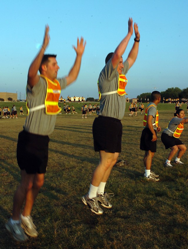 Members of the Headquarters and Headquarters Company, Special Troops Battalion, 15th Sustainment Brigade, jump during the "burpee" CrossFit exercise June 4. The burpee is an exercise that combines a pushup with a high jump. The unit is incorporating ...