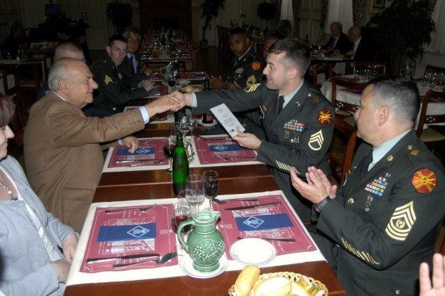 Brussels NCO Attains Education Milestone