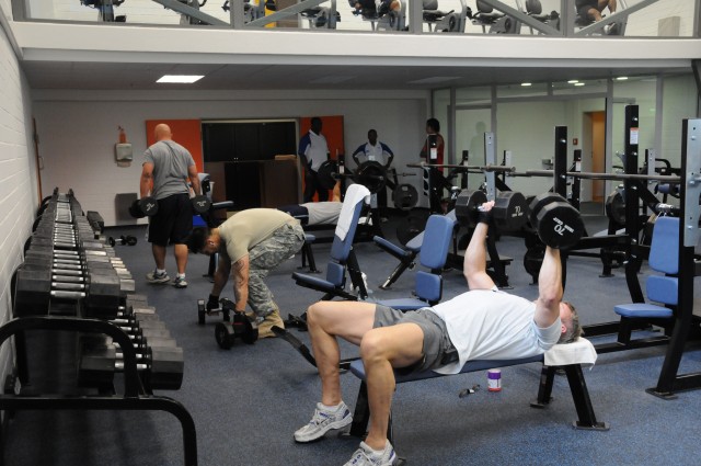 Family and Morale, Welfare and Recreation patrons use free weights following the grand re-opening of the U.S. Army Garrison Hohenfels, Germany, post gym May 18. Thanks to funding from Installation Management Command, USAG Hohenfels now has one compre...