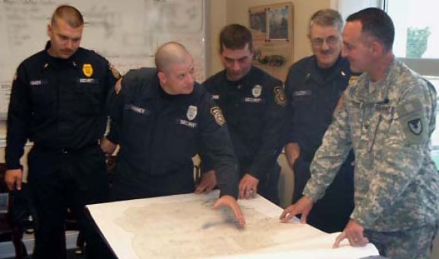 Heroic Employees Review Plans with Blue Grass Commander