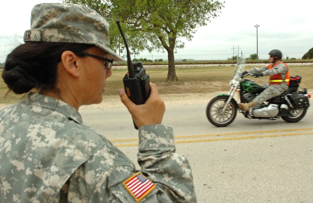 Master Sgt. Celia Feller, Phantom Thunder II's non-commissioned officer in charge, monitors radio traffic as riders leave the staging area for the motorcycle safety ride at Hood Stadium here, June 11. (U.S. Army photo by Sgt. Matthew C. Cooley,...
