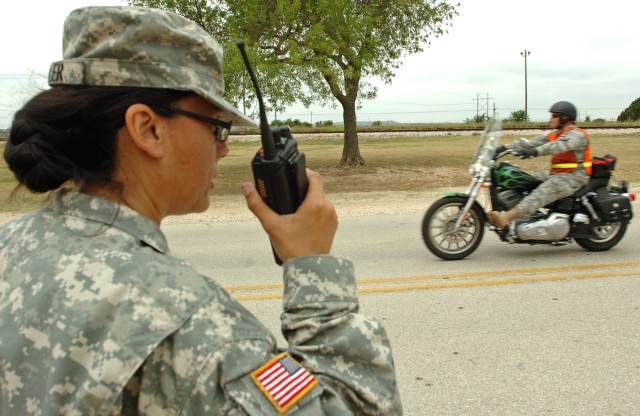 Master Sgt. Celia Feller, Phantom Thunder II's non-commissioned officer in charge, monitors radio traffic as riders leave the staging area for the motorcycle safety ride at Hood Stadium here, June 11. (U.S. Army photo by Sgt. Matthew C. Cooley, 15th ...