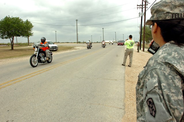 Master Sgt. Celia Feller, Phantom Thunder II's non-commissioned officer in charge, monitors radio traffic as riders leave the staging area for the motorcycle safety ride at Hood Stadium here, June 11. (U.S. Army photo by Sgt. Matthew C. Cooley, 15th ...