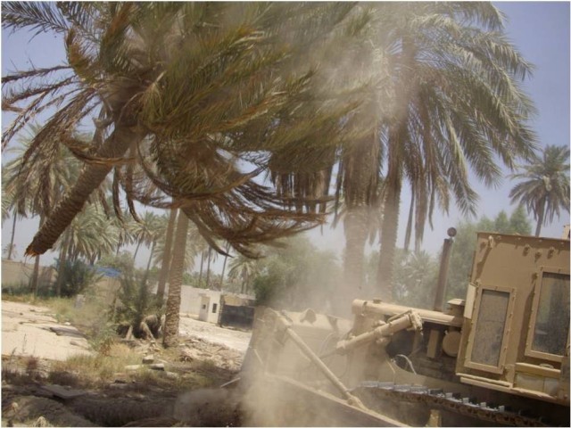 BAGHDAD - A heavy equipment operator with the 46th Engineer Combat Battalion (Heavy), 225th Engineer Brigade, uses a bulldozer to clear trees from the Helicopter Landing Zone at Forward Operating Base Justice as part of a three week project to better...
