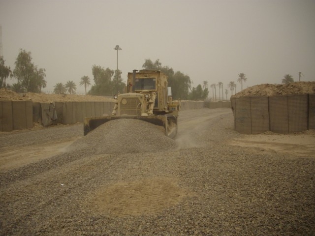 BAGHDAD - A heavy equipment operator, Equipment Platoon, 46th Engineer Combat Battalion (Heavy), 225th Engineer Brigade, uses a bulldozer to redistribute and level gravel around the ranges at Forward Operating Base Justice. The three week project...