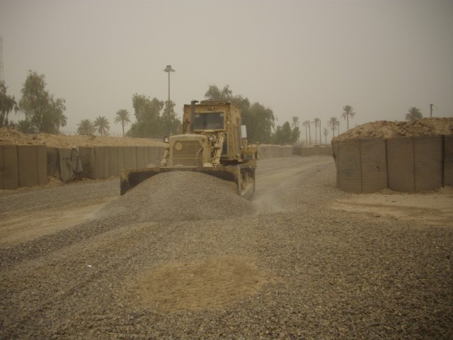 BAGHDAD - A heavy equipment operator, Equipment Platoon, 46th Engineer Combat Battalion (Heavy), 225th Engineer Brigade, uses a bulldozer to redistribute and level gravel around the ranges at Forward Operating Base Justice. The three week project con...