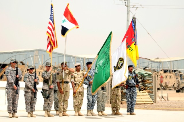 BAGHDAD - Soldiers in from the 30th Heavy Brigade Combat Team; 2nd Brigade Combat Team, 1st Armored Division,and the 17th Iraqi Army, display their colors during the transfer of authority ceremony at Forward Operating Base Falcon. The May 26 ceremony...