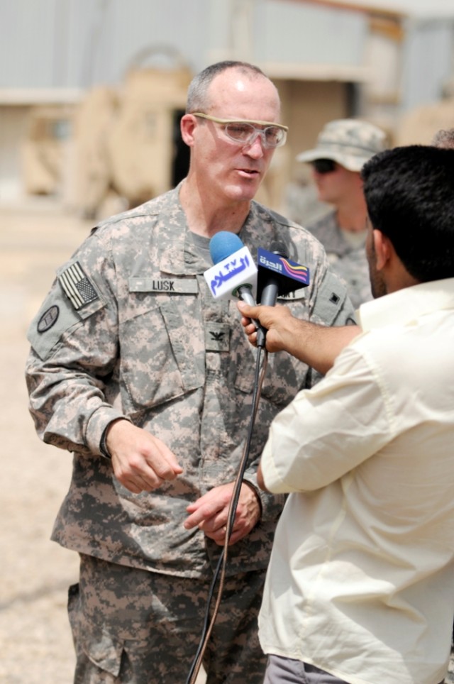 BAGHDAD - Col. Gregory Lusk, brigade commander for the 30th Heavy Brigade Combat Team, Multi-National Division-Baghdad (left), is interviewed by members of the Iraqi Media, after the transfer of authority ceremony at forward operating base falcon, Ma...