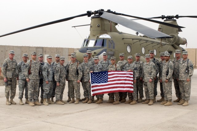 CAMP TAJI, Iraq-Senior warrant officers from the 1st Air Cavalry Brigade, 1st Cavalry Division, Multi-National Division-Baghdad, and 4th Combat Aviation Brigade, 4th Infantry Division, stand together in front of a CH-47F Chinook helicopter, May...