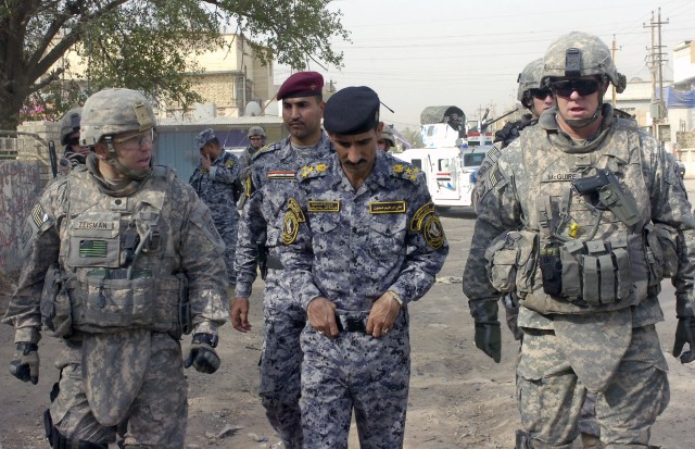 BAGHDAD - Lt. Col. Louis Zeisman (left), of Fayetteville, N.C., along with Iraqi Brig. Gen. Ali Ibraheem Dabown (center), commander of the 8th National Police Brigade, 2nd NP Division, and Col. Timothy McGuire (right), of Alamo, Calif., commander...