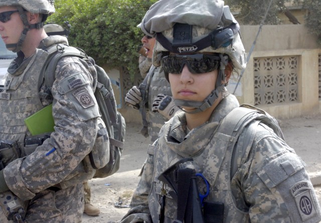 BAGHDAD - Spc. Loren Combs (right), of Forsyth, Mo., a medic assigned to Company C, Brigade Support Battalion, 3rd Brigade Combat Team, 82nd Airborne Division, Multi-National Division-Baghdad, checks her surroundings during Operation Asfah...