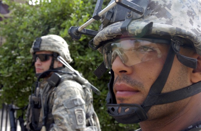 BAGHDAD - A National Policeman (right), assigned to 8th National Police Brigade, 2nd NP Division, and a Paratrooper assigned to the 2nd Battalion, 505th Parachute Infantry Regiment, 3rd Brigade Combat Team, 82nd Airborne Division, Multi-National...