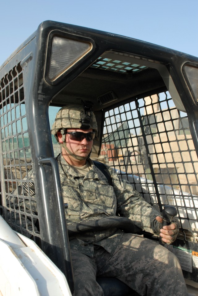BAGHDAD - Muskegon, Mich., native, Pfc. Robert Corlew, a supply specialist assigned to Headquarters and Headquarters Company, 2nd Squadron, 5th Cavalry Regiment, 1st Brigade Combat Team, 1st Cavalry Division, operates a forklift at Joint Security...