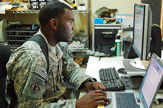 BAGHDAD - Spc. Jason Givens, a supply sergeant assistant with Headquarters and Headquarters Company, 120th Combined Arms Battalion, 30th Heavy Brigade Combat Team, Multi-National Division-Baghdad, checks supply records to make sure they are updated, ...