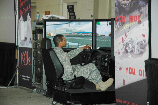 APG Soldier attempts driving in drunk-driving simulator