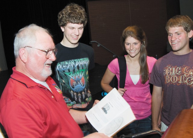 Former NASA Flight Controller Sy Liebergot discusses his book, 'Apollo EECOM - Journey of a Lifetime,' with C. Milton Wright High School students, from left, Adam Keith Smith, Cara Canington and Justin Greer, during his visit to their school in May. ...