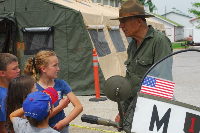 Army Pfc. (ret.) Bill Kreider, a participant in the 90th anniversary of the first transcontinental convoy and a resident of Carson City, Nev. talks to a group of children about military life during World War II here recently. The local event...
