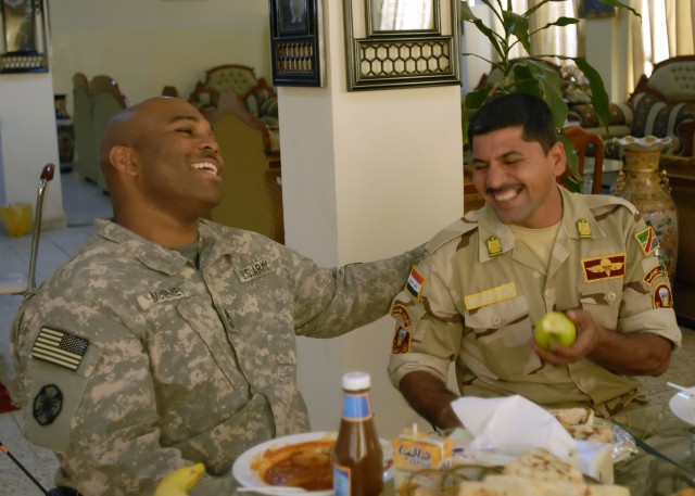 BAGHDAD - Master Sgt. Moty McKinney (left), a native of Saginaw, Mich., an advisor with the 24th Brigade, 6th Iraqi Army Division Military Training and Transition Team, shares a laugh with Command Sgt. Maj. Mahmud Lafta, 24th Bde. 6th I.A. Div.,...