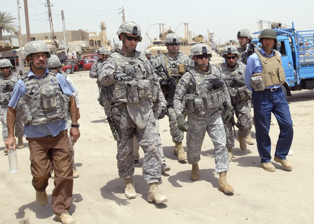 BAGHDAD - Lt Col. Christopher Beckert (second from left), a native of Madison, Conn., deputy commander, 2nd Heavy Brigade Combat Team, 1st Infantry Division, Multi-National Division-Baghdad, speaks with Lt. Gen. Charles Jacoby (center), commander, Mu...