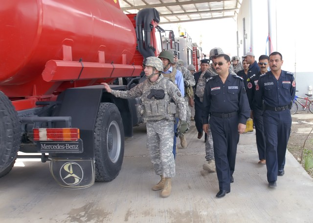 BAGHDAD - Lt. Gen Charles Jacoby (left), commander, Multi-National Corps - Iraq, takes a tour of the recently opened Abu Ghraib Fire Station, May 28. Jacoby handed out coins to Soldiers serving with the 2nd Heavy Brigade Combat Team, 1st Infantry Div...