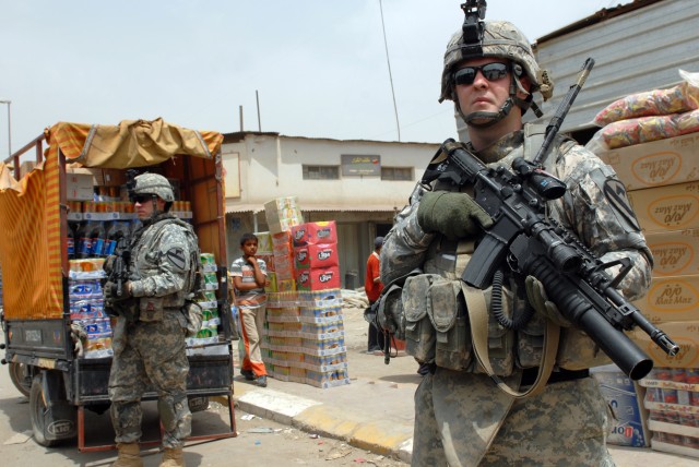 BAGHDAD - Pvt. Justin Smith (left), a combat medic from Raeford, N.C., and Cpl. Shane Smith (right), an infantryman team leader from Worcester, Mass., both assigned to Company B, 2nd Battalion, 5th Cavalry Regiment, 1st Brigade Combat Team, 1st...