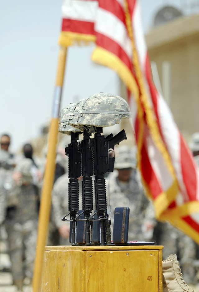 BAGHDAD-The timed honored memorial of helmet, rifle, dog tags and boots stands for three Soldiers from the 252nd Combined Arms Battalion, 30th Heavy Brigade Combat Team, during a memorial service, May 29, at Forward Operating Base Falcon on the south...