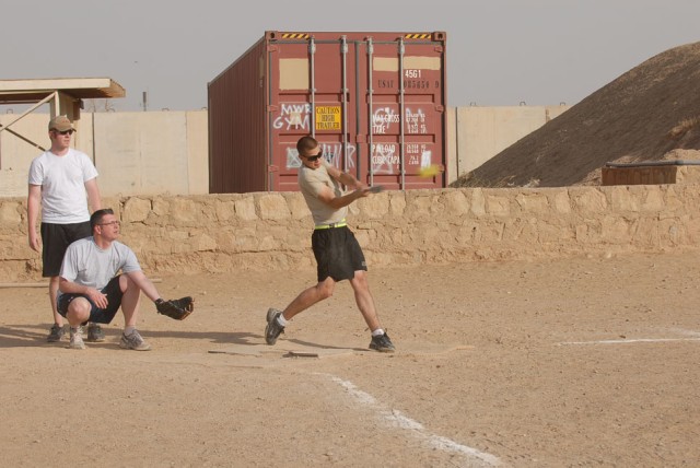 Pfc. Curtis Wall, a Hollister, Calif., native and an infantryman with Headquarters and Headquarters Company, 2nd Brigade Combat Team, 1st Cavalry Division, gets a solid hit on a softball during a game on Forward Operating Base Warrior May 13. The...
