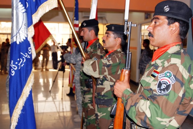 A mix of Iraqi Police and U.S. Soldiers act as the color guard during a ceremony May 19 at the Provincial Joint Control Center in Kirkuk city, Iraq, which honored four IP and one Kirkuk resident who stopped a would-be suicide bomber from...