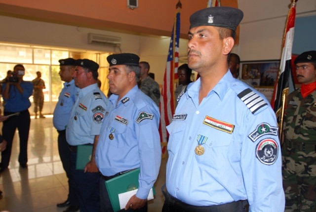 Four Iraqi Policemen stand together after receiving Army Achievement Medals during a ceremony May 19 at the Provincial Joint Control Center in Kirkuk city, Iraq. The police officers were honored for stopping a suicide bomber earlier this month who...