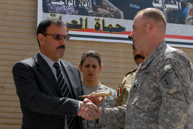 BAGHDAD - Lt. Col. John Vermeesch (right), a Roscommon, Mich., native and commander of 1st Battalion, 18th Infantry Regiment, 2nd Brigade Combat Team, 1st Infantry Division, shakes hands with Samir Hadad, the secretary director for the prime...