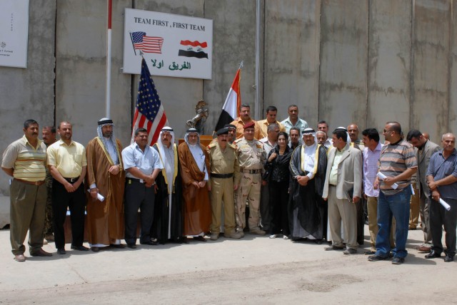 BAGHDAD - The senior leadership of the Iraqi Army, Iraqi Police and Sons of Iraq security members that are partnered with the 1st "Ironhorse" Brigade Combat Team, 1st Cavalry Division, gather together for a group photo after the SoI Conference,...
