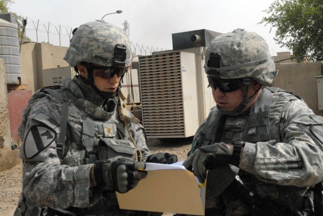 BAGHDAD- Boulder, Colo. Native, Maj. Geoffrey Norman, 1st "Ironhorse" Brigade Combat Team executive officer, speaks with Poolesville, Md. Native, Maj. Sean Davis, support operations officer for 115th Brigade Support Battalion, 1st Brigade Combat...