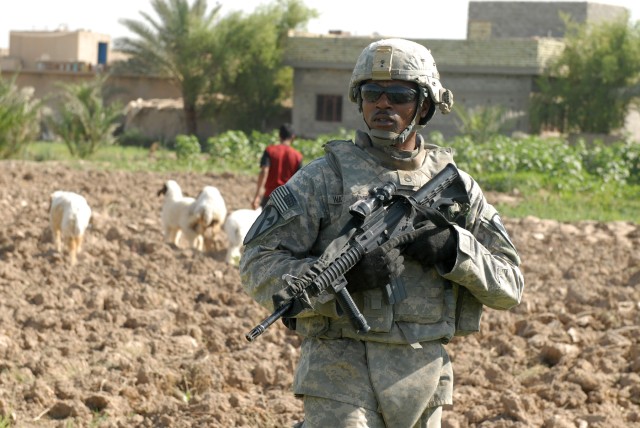 BAGHDAD - Staff Sgt. Harold Waterman, an artilleryman assigned to Battery B, 1st Battalion, 82nd Field Artillery Regiment, 3rd Brigade Combat Team, 82nd Airborne Division, pulls security during a reconnaissance of a field in Jisr Diyala where a...